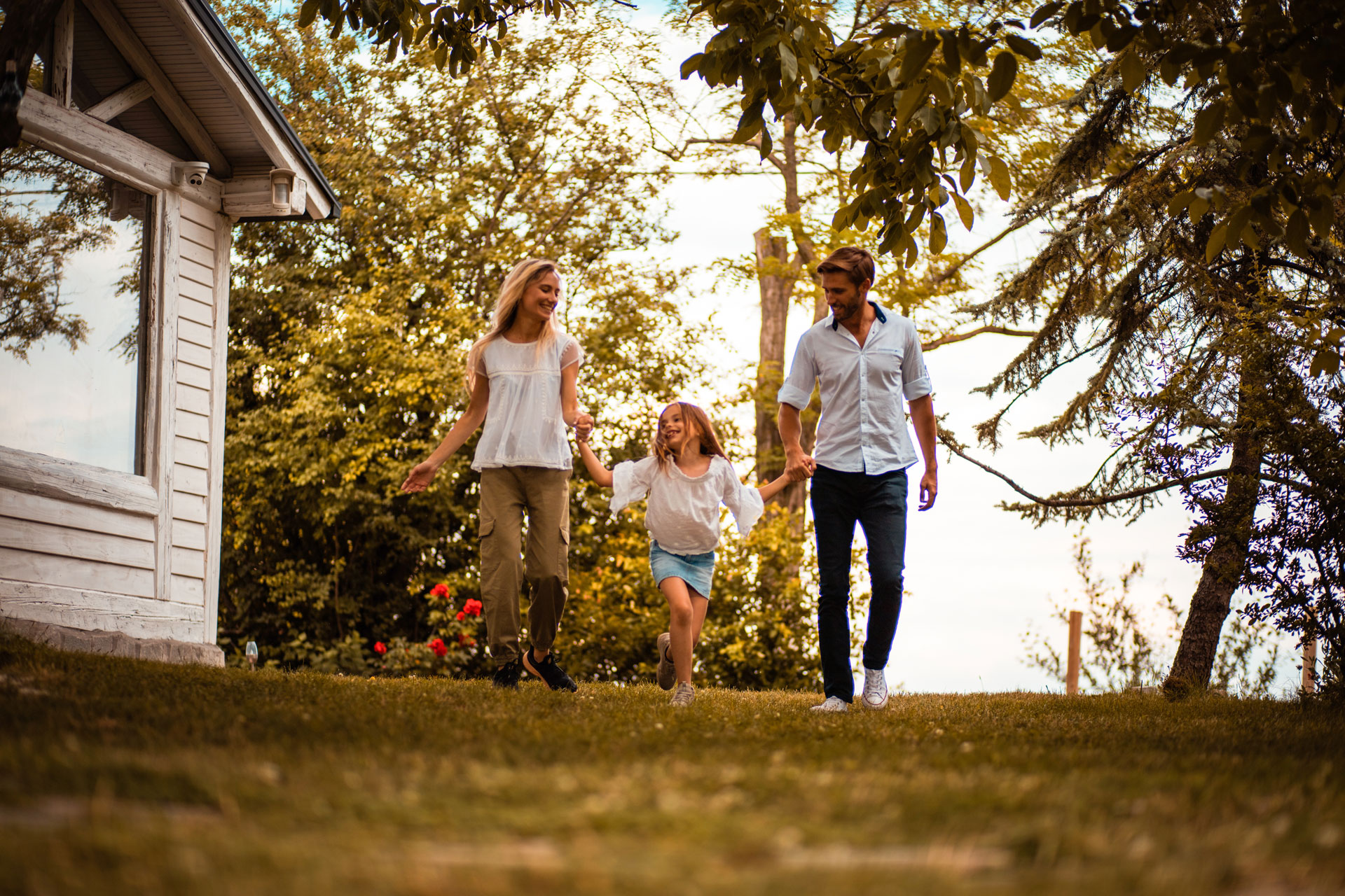 Couple with kid outside a rural home