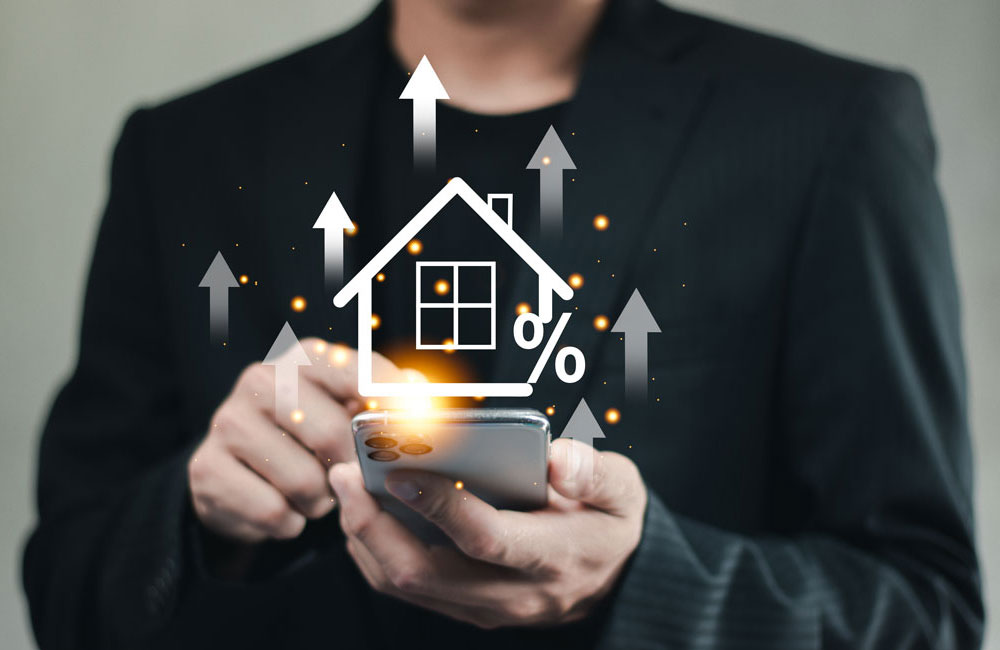 property-value-up-1000x650-1 Graphic of a man with a home illustration in front of him